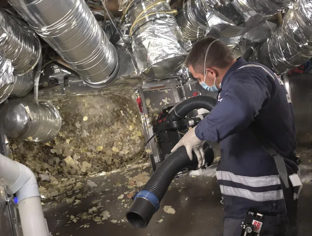 Rockland Air Duct Cleaning specialist operating negative pressure cleaning equipment for thorough duct maintenance in Rockland
